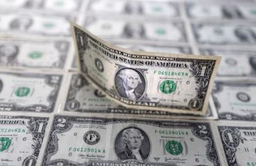 US dollar nearly flat after dipping on soft inflation