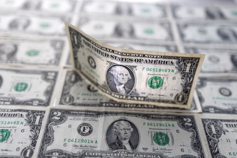 US dollar nearly flat after dipping on soft inflation