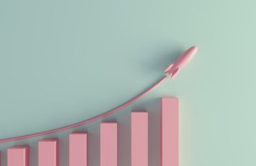 A rising bar chart with a toy-like rocket flying above it.