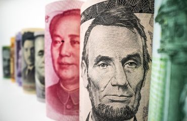 Picture of rolls of currency, with a focus on Abe Lincoln and the US dollar